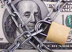Image of U.S. currency behind chains and lock