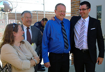 Michael Parker, second from right, is greeted on his release from prison by members of his legal team, from right: Benjamin Glover, Sean Devereux T'69, and Buffy Skolnick, Devereux's assistant